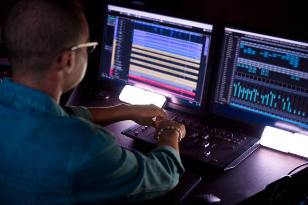 Audio engineer working at mixing console
